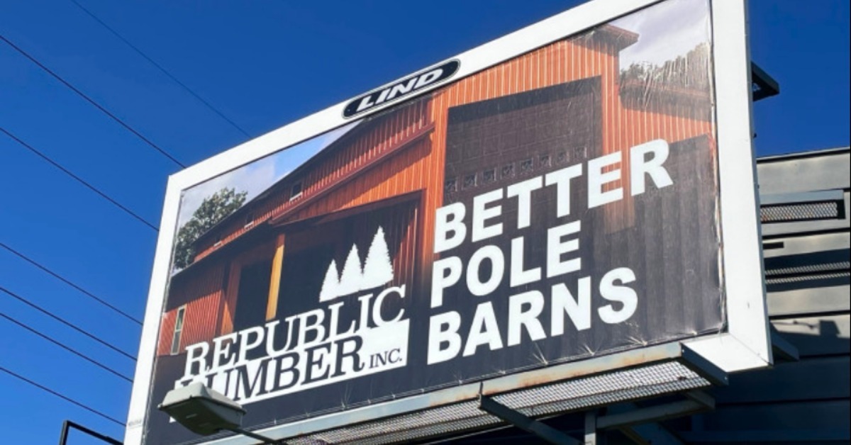 Republic Lumber Inc Pole Barns banner against a bright blue sky