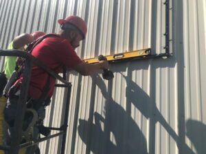 2-guys-leveling-out-the-poster-frame-300x225 Lind SignSpring: Custom Banner Signs for Your Business