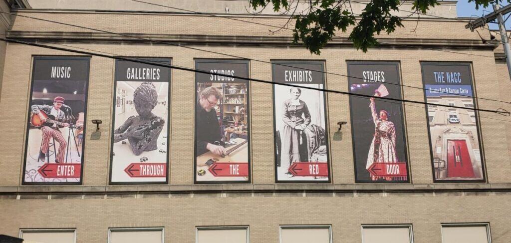 Brick-Building-with-Banner-Posters-hung-up-1024x487 Lind BannerFrame CLASSIC: Custom Banner Signs for Your Aging Brick Wall