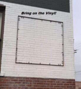 Frame-put-together-on-brick-wall-waiting-for-vinyl-1-274x300 Lind Banner Frame DELUXE! Signage Displays the Upscale Way!