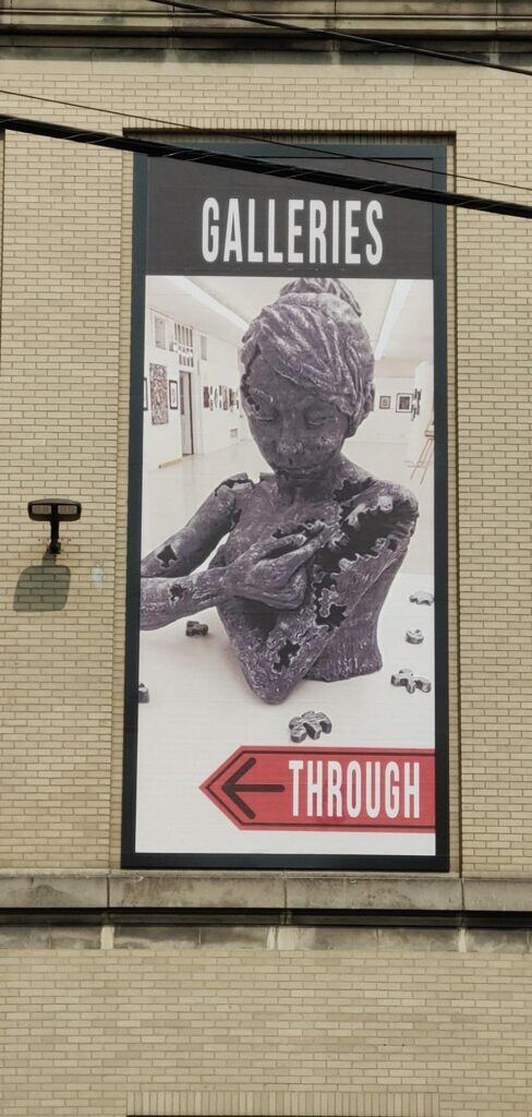 Picture-of-a-statue-with-the-word-galleries-488x1024 Lind BannerFrame CLASSIC: Custom Banner Signs for Your Aging Brick Wall