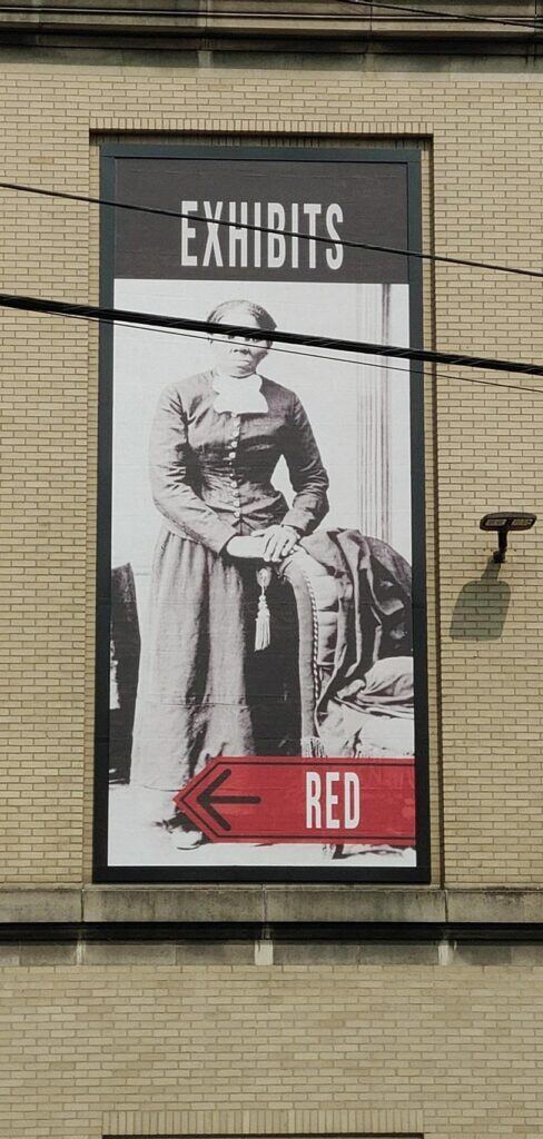 Poster-of-an-history-exhibit-488x1024 Lind BannerFrame CLASSIC: Custom Banner Signs for Your Aging Brick Wall