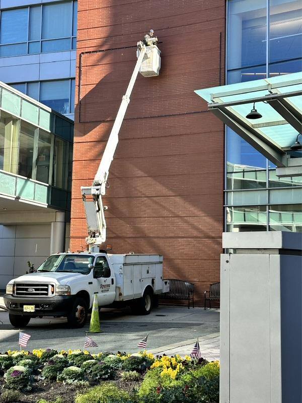 Signarama-AtlantiCare-install-2-BannerFrame-Classic-Banners-bucket-truck-frame-installed Sign Shops Love Lind Banner Frame