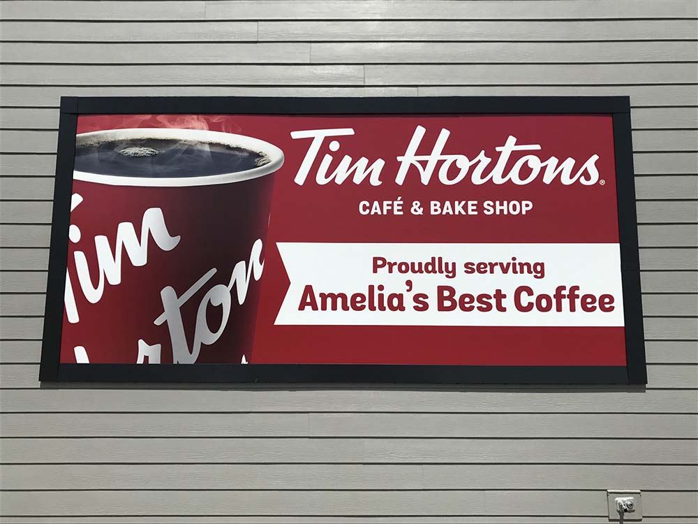 A Lind SignSpring Product – BannerFrameHINGE on the exterior brick wall of Tim Hortons. Side Panels Closed-Photo 2