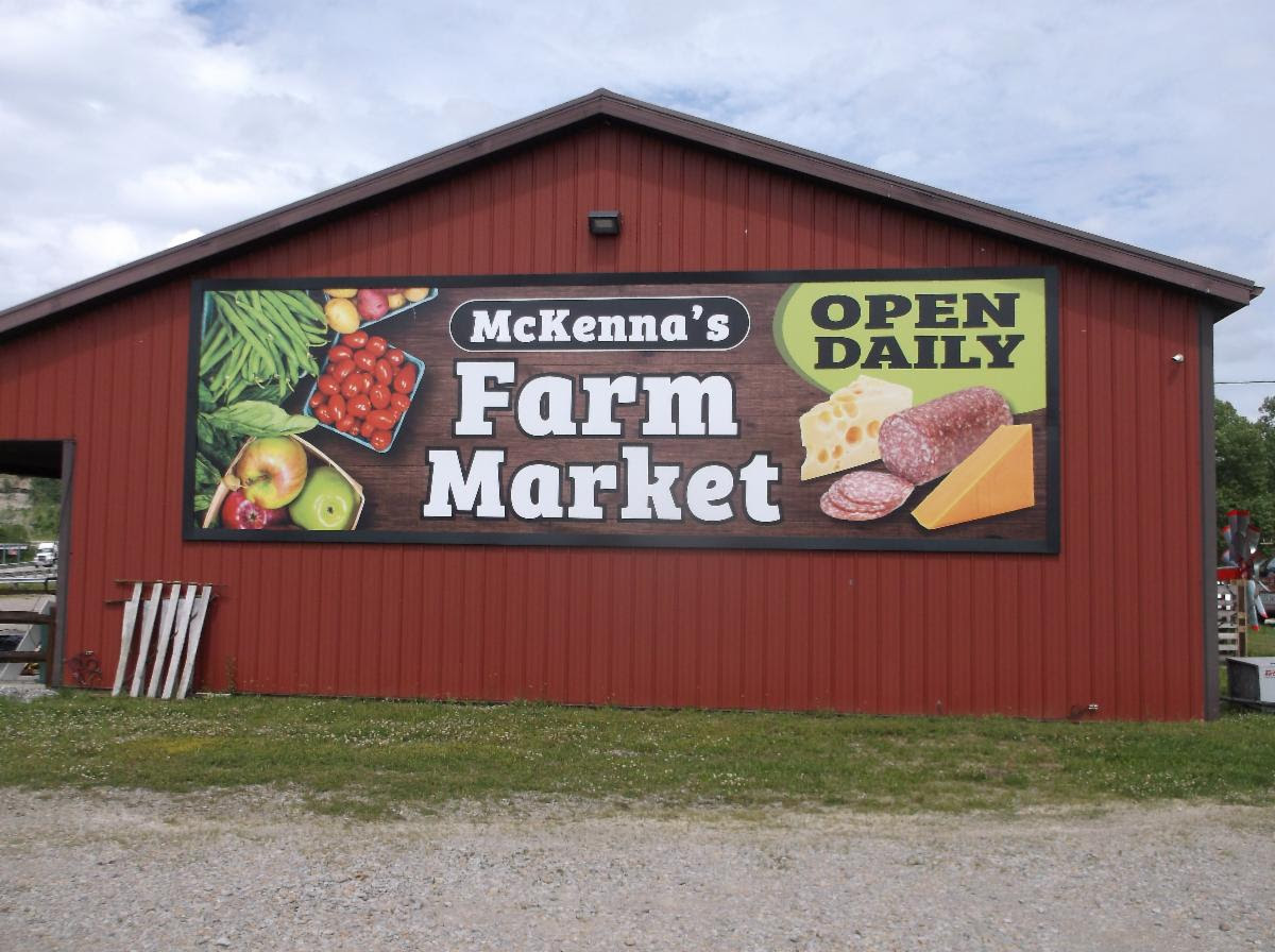 A Lind SignSpring Product – BannerFrameCLASSIC With Covers for McKenna’s Farm Market on exterior metal siding