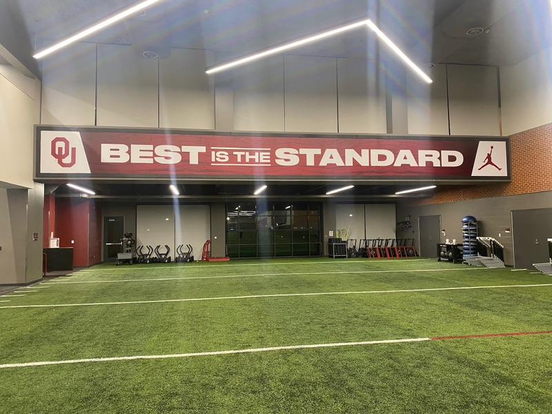 Lindmark-Banner-in-indoor-training-center-OU-Lind-SignSpring-BannerFrame-Classic-with-covers Buckeyes Cover Sooners!