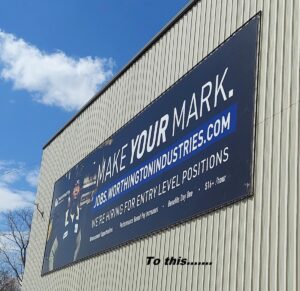 Poster-up-on-building-300x291 Steel Your Face! Banner Hanging Systems for Metal Siding!